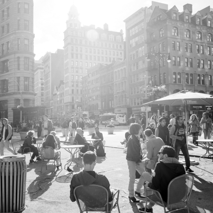 People enjoying sunny day NYC Flatiron Plaza